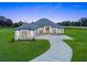 Stunning single-story home featuring a modern design, a long driveway, and a lush green lawn at 7041 Ne 22Nd Court Rd, Ocala, FL 34479