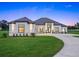 Beautifully landscaped single story-home featuring large windows, a modern design, and a concrete driveway at 7041 Ne 22Nd Court Rd, Ocala, FL 34479