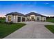 Beautiful single-story home featuring a modern design, 2-car garage and a long concrete driveway at 7041 Ne 22Nd Court Rd, Ocala, FL 34479