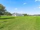 Expansive backyard featuring a well-maintained lawn and a modern house design at 7041 Ne 22Nd Court Rd, Ocala, FL 34479