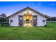 Exterior of horse barn featuring a sign and rustic accents, set against a backdrop of expansive greenery at 7041 Ne 22Nd Court Rd, Ocala, FL 34479