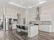 Well-appointed kitchen features white cabinetry, stainless steel appliances, a stylish backsplash, and an island with seating at 7041 Ne 22Nd Court Rd, Ocala, FL 34479