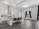 Kitchen with white cabinets, granite countertops, mosaic backsplash, and seating at the island at 7041 Ne 22Nd Court Rd, Ocala, FL 34479