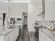 Modern kitchen with white cabinets, granite countertops, and stainless steel appliances at 7041 Ne 22Nd Court Rd, Ocala, FL 34479