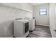 Functional laundry room with modern washer/dryer, wire shelving, and durable floors at 7041 Ne 22Nd Court Rd, Ocala, FL 34479