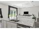 Open living room with stone countertops, stainless steel sink, plenty of natural light, and a view of the green backyard at 7041 Ne 22Nd Court Rd, Ocala, FL 34479