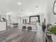 Open-concept living space with a large window offering views of the lush, green pasture at 7041 Ne 22Nd Court Rd, Ocala, FL 34479