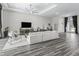 Spacious open-concept living room featuring hardwood floors and plenty of natural light at 7041 Ne 22Nd Court Rd, Ocala, FL 34479