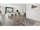 Bright living room with plank flooring, recessed lighting, and picture window with backyard view at 7041 Ne 22Nd Court Rd, Ocala, FL 34479