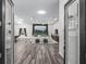 An open-concept living space with hardwood floors, high ceilings, and expansive windows at 7041 Ne 22Nd Court Rd, Ocala, FL 34479
