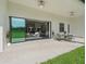 Relaxing outdoor living area with a covered patio and sliding glass doors with open access to the great room at 7041 Ne 22Nd Court Rd, Ocala, FL 34479