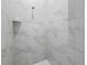 Modern shower with sleek marble tiling and a rainfall shower head for a spa-like experience at 7041 Ne 22Nd Court Rd, Ocala, FL 34479