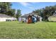 Large backyard with playset and ample space for outdoor activities at 710 Barwick St, Wildwood, FL 34785