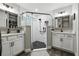 Modern bathroom with a glass-enclosed shower, dual vanities, and updated fixtures at 710 Barwick St, Wildwood, FL 34785