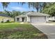 Charming single-story home with a two-car garage, green lawn, and inviting curb appeal at 710 Barwick St, Wildwood, FL 34785