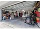 Spacious garage with ample storage, tools, and a lawn mower at 710 Barwick St, Wildwood, FL 34785