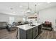 Well-designed kitchen with a large island, bar seating, and open view to living and dining areas at 710 Barwick St, Wildwood, FL 34785