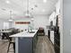 Modern kitchen featuring stainless steel appliances, a center island, and elegant pendant lighting at 710 Barwick St, Wildwood, FL 34785