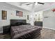 Comfortable main bedroom featuring a ceiling fan, wood flooring, and decorative star accents at 710 Barwick St, Wildwood, FL 34785