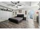 Comfortable main bedroom featuring trey ceilings, modern decor, and an attached bathroom with large shower at 710 Barwick St, Wildwood, FL 34785
