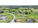 Expansive aerial view showcasing numerous homes in a green community, and the winding roads through the neighborhood at 7220 Nw 83 Ter, Ocala, FL 34482
