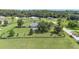 Beautiful home surrounded by a large, fenced yard, featuring a screened pool and serene landscape, ideal for outdoor living at 7220 Nw 83 Ter, Ocala, FL 34482