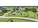 Beautiful aerial view of a brick home with a fenced yard, surrounded by lush greenery and other charming properties at 7220 Nw 83 Ter, Ocala, FL 34482