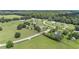 Spacious homesites in a well-manicured rural setting, featuring lush lawns and mature trees, with country fencing and paved roads at 7220 Nw 83 Ter, Ocala, FL 34482