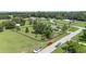 Expansive property featuring a home with fenced yard, surrounded by lush greenery and mature trees in a serene neighborhood at 7220 Nw 83 Ter, Ocala, FL 34482