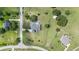 Aerial view of house with an enclosed pool and surrounding greenery, showing the property layout from above at 7220 Nw 83 Ter, Ocala, FL 34482