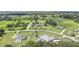 High aerial view of multiple properties in a green community, showcasing large lawns and privacy at 7220 Nw 83 Ter, Ocala, FL 34482