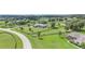 Stunning aerial view of the property, showcasing the well-manicured lawn, mature trees, and neighboring homes at 7220 Nw 83 Ter, Ocala, FL 34482
