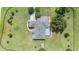 Top-down aerial view highlighting the roof design, enclosed pool, expansive yard, and tree-lined property boundaries at 7220 Nw 83 Ter, Ocala, FL 34482