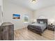 Neutral bedroom with wood floors, and a large window overlooking the outside at 7220 Nw 83 Ter, Ocala, FL 34482