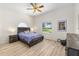 Inviting bedroom featuring wood floors, a ceiling fan, and natural lighting at 7220 Nw 83 Ter, Ocala, FL 34482