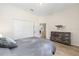 Bright bedroom featuring wood floors, closet, and wooden dresser with horse picture at 7220 Nw 83 Ter, Ocala, FL 34482