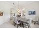 Bright dining room featuring table with six chairs, decorative artwork, and tile flooring at 7220 Nw 83 Ter, Ocala, FL 34482