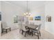 Bright dining room featuring a chandelier, table with six chairs, and neutral decor at 7220 Nw 83 Ter, Ocala, FL 34482