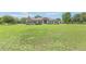 Well-manicured lawn and a home featuring a stone-accented facade, lush landscaping, and an expansive green lawn at 7220 Nw 83 Ter, Ocala, FL 34482