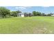 Expansive lawn surrounding a charming home with a lush green field, and a serene countryside backdrop at 7220 Nw 83 Ter, Ocala, FL 34482