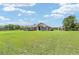 Expansive front yard, a house with a serene rural setting, and a charming shed adding to the property's appeal at 7220 Nw 83 Ter, Ocala, FL 34482