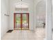 Welcoming foyer with a double-door entryway and views of the landscaped exterior at 7220 Nw 83 Ter, Ocala, FL 34482