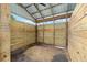 View of the horse stall's wooden plank walls and metal roof, providing shelter and a comfortable space for horses at 7220 Nw 83 Ter, Ocala, FL 34482