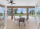Screened lanai with table and chairs offering views of the pool and large backyard at 7220 Nw 83 Ter, Ocala, FL 34482