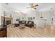 Spacious living room with stone fireplace, wood floors, and neutral colored sectional at 7220 Nw 83 Ter, Ocala, FL 34482