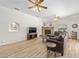 Living room featuring wood floors, stone fireplace, and large sectional sofa at 7220 Nw 83 Ter, Ocala, FL 34482