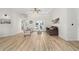 Open-concept living room features a ceiling fan and access to outdoor spaces at 7220 Nw 83 Ter, Ocala, FL 34482