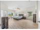 Spacious main bedroom with a large window and wood floors at 7220 Nw 83 Ter, Ocala, FL 34482