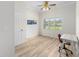 Office space featuring wood flooring, large window, and a light-colored desk and chair at 7220 Nw 83 Ter, Ocala, FL 34482