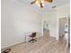 Office space featuring wood flooring, view of an arched doorway, and a light-colored desk and chair at 7220 Nw 83 Ter, Ocala, FL 34482